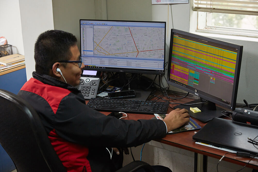 man sitting at desktop computer using apex