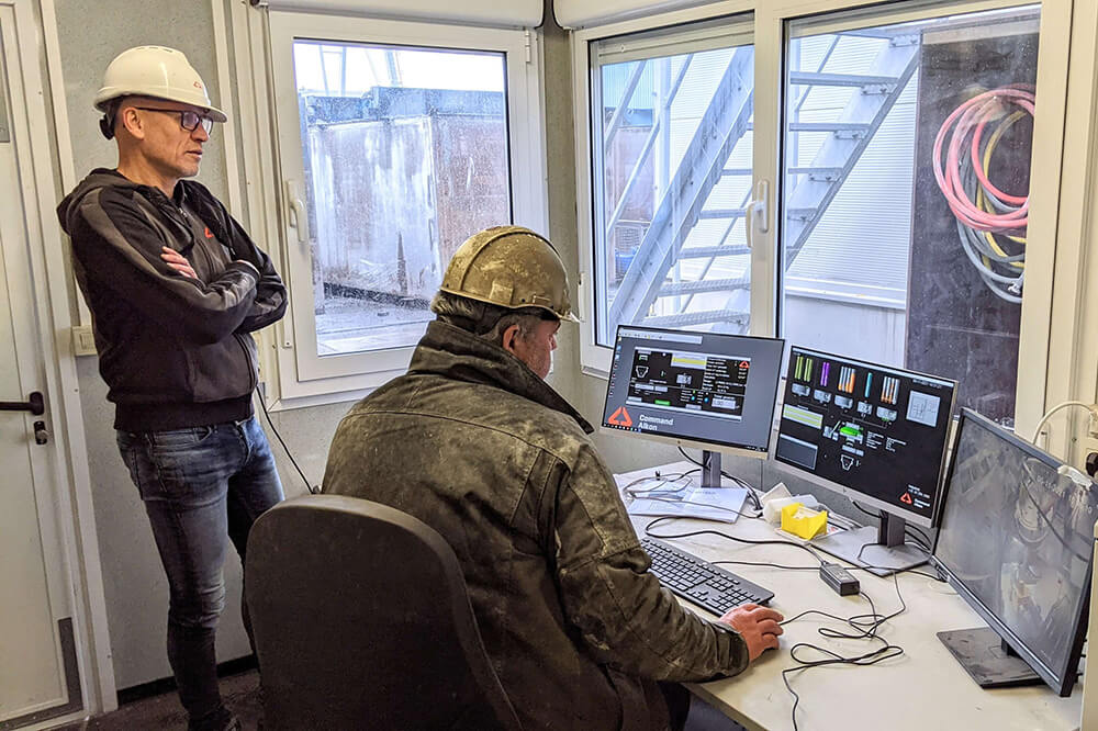 female construction worker holding a tablet and smiling